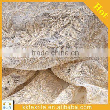 100% polyester mesh with white and gold thread embroidery design