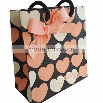 decorated paper bag with bow tie ribbon for gift