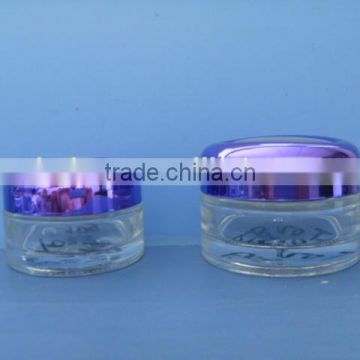 Clear body cream jar with purple Alumite cap