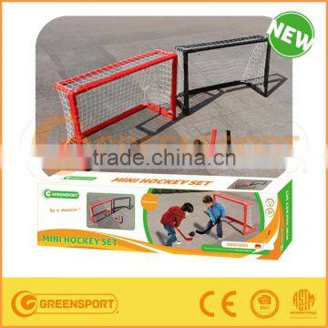 mini hockey goal with 2 goals and hockey sticks