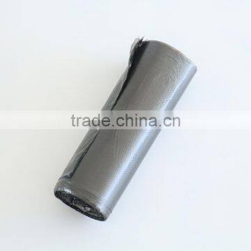 Black plastic garbage packing bag in roll