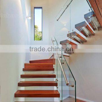 floating stairs with frameless glass balustrade and oak tread and stainless steel hadnrail