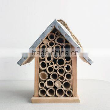 Wooden insect house with iron roof