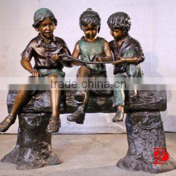 Garden bronze children sculptures Sitting and palyiny a butterfly