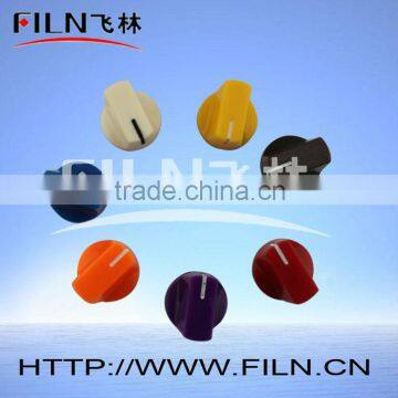 yellow colored round plastic guitar volume knob