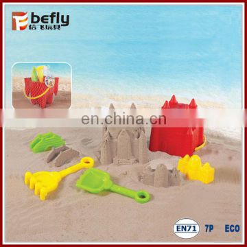 Red plastic sand castle buckets with spade