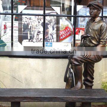 outdoor life size bronze sculpture of a caddy with a bench