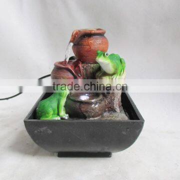 Resin table water fountain with two frogs on it