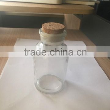 Glass bottle with wooden lid