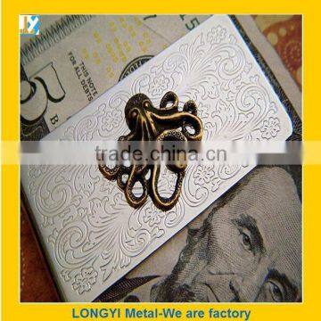 silver metal money clip with carving logo