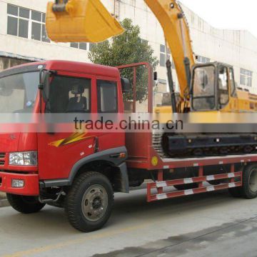 Flat bed construction machine towing flat bed transport truck