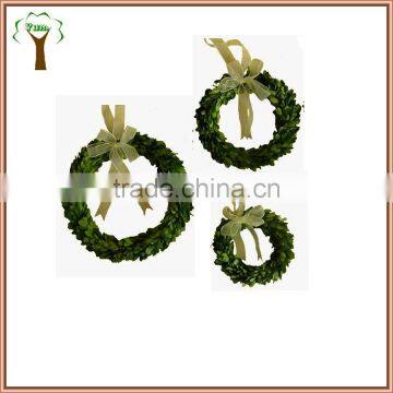 different sizes of preserved boxwood wreath with white silk bow