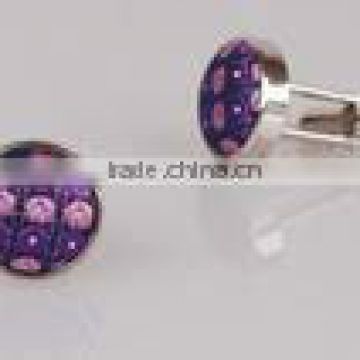 A purple crystal cufflink