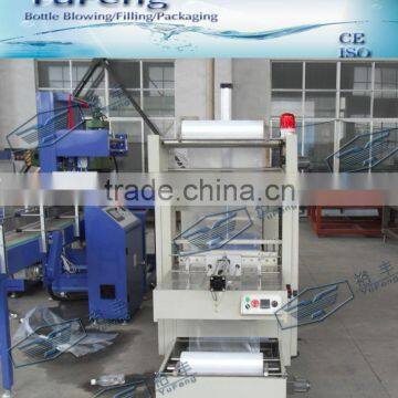 Automatic shrink wrapping machine