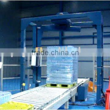 CONVEYORIZED STRETCH WRAPPING MACHINE