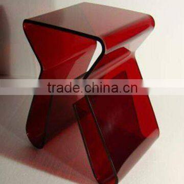 red acrylic plastic chairs with bookcase