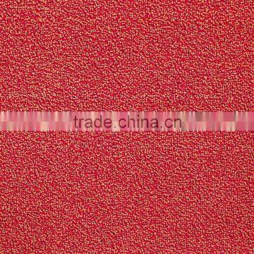 Machine tufted loop pile wall to wall carpet