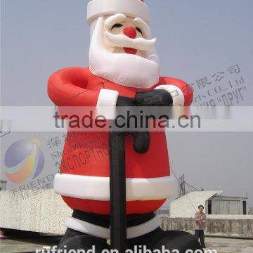 Inflatable Santa Claus with a large sugar cane Christmas decorations