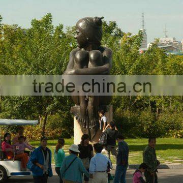 Bronze seated nude lady garden statue