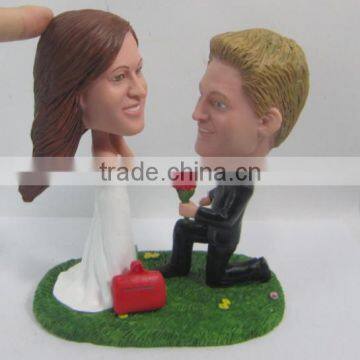 groom make a proposal of marrie to bride figurine