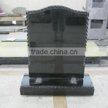 European style carved black granite tombstone