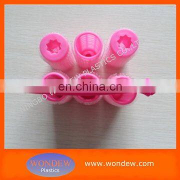 Self-gripping hair roller with plastic handle