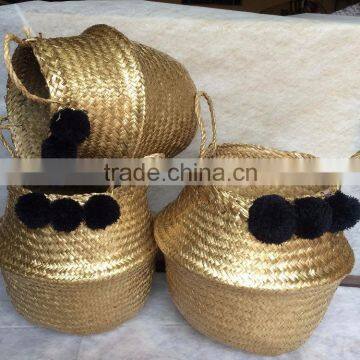 Best selling gold seagrass belly basket with black pompoms