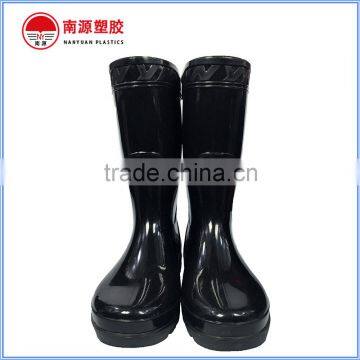 Shiny black plastic half cut rain boots for construction work