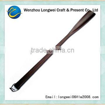 long polished wooden shoehorn/shoe lifter