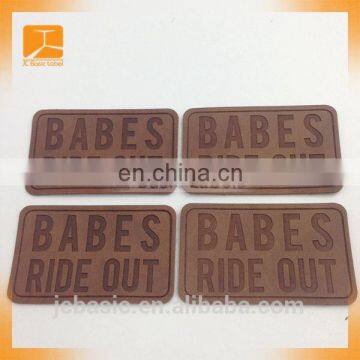 Oeko-tex wholesale custom labels jeans jacket embossed logo laser cut embossed pu leather patch for garment