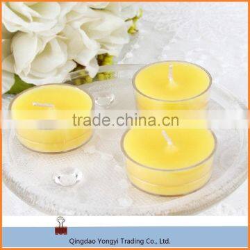 scented and colored tealight candle in plastic cup