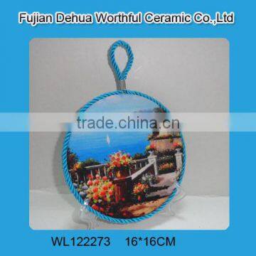 Round ceramic pot holder with blue lifting rope