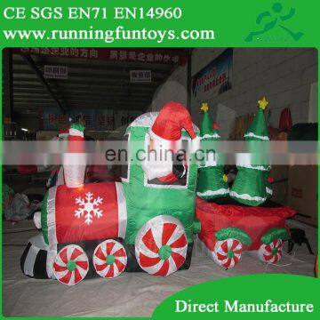 Inflatable Santa Claus Driving Train on Candy Wheels Pulling Christmas Trees