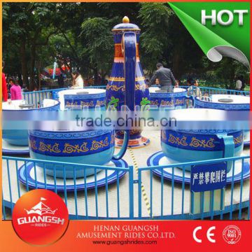 Fun fairground rotary tea cup rides amusement