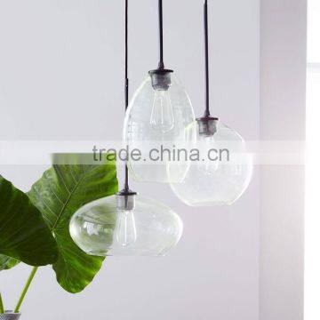 11.26-6 With glass shades in a slight green tint Glass Triplet Chandelier three shades vary in size and hanging height