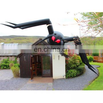 outdoor giant spider halloween inflatable on roof buidling