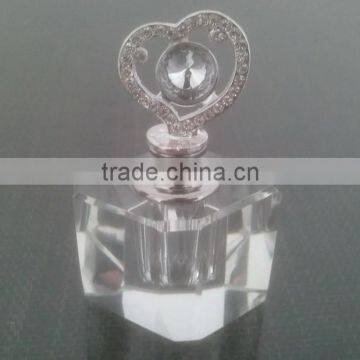 small empty clear crystal perfume bottle with jewelled metal alloy handle