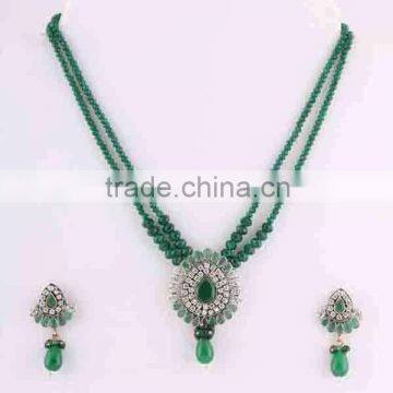 Indian manufacturers green gemstone CZ necklace with earrings party wear wedding jewellery. Brass metal.