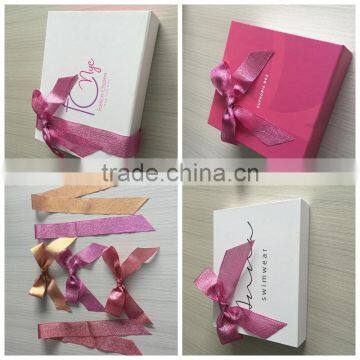 Christmas day gift decorations metallic ribbon bow on gift box , looks stretchable and shiny