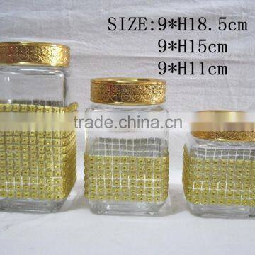 Three golden glass storage jar/square storage tank