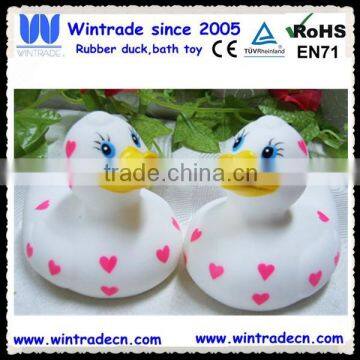 White rubber duck with pink heart