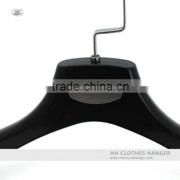 The empty plastic suit hanger,shiny finish,metal logo placque,can hanging bar