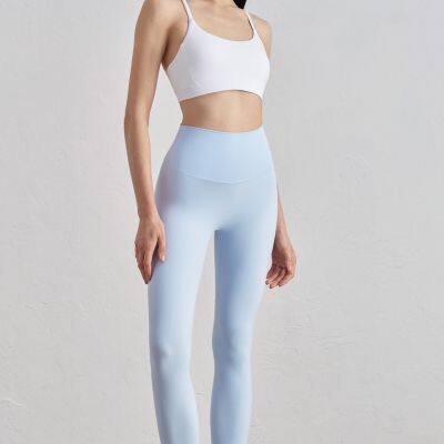 Großhandel: Frauen Yoga-Hosen aus NULS-Gewebe, eng anliegend, pfirsichfarben, mit Hochbund und angehobenem Sitz