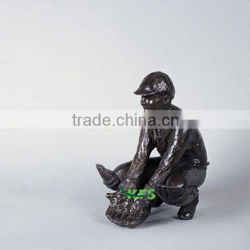 Bronze indoor sculpture of wicket keeper boy