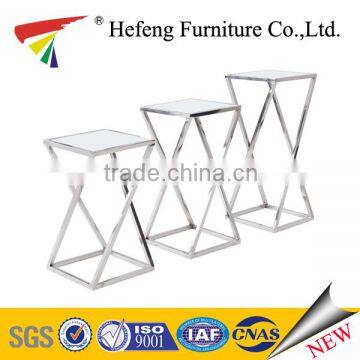 Stainless steel frame with glass top nesting table