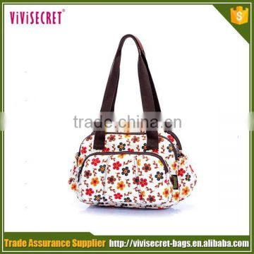 Designer holding baby bag adult diaper bag