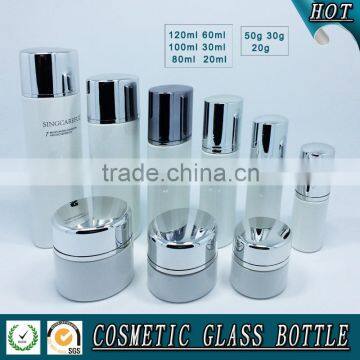 White coloured glass cosmetics bottle and cosmetic glass cream jar