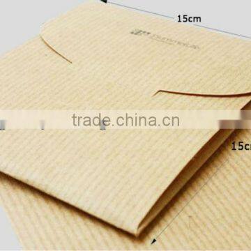 Hard kraft paper envelope with die cut enclosure