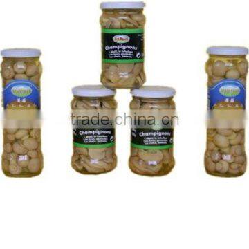 Fresh canned champignons whole in glass jar