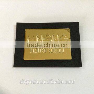 Glitter gold metal embossed logo on black leather